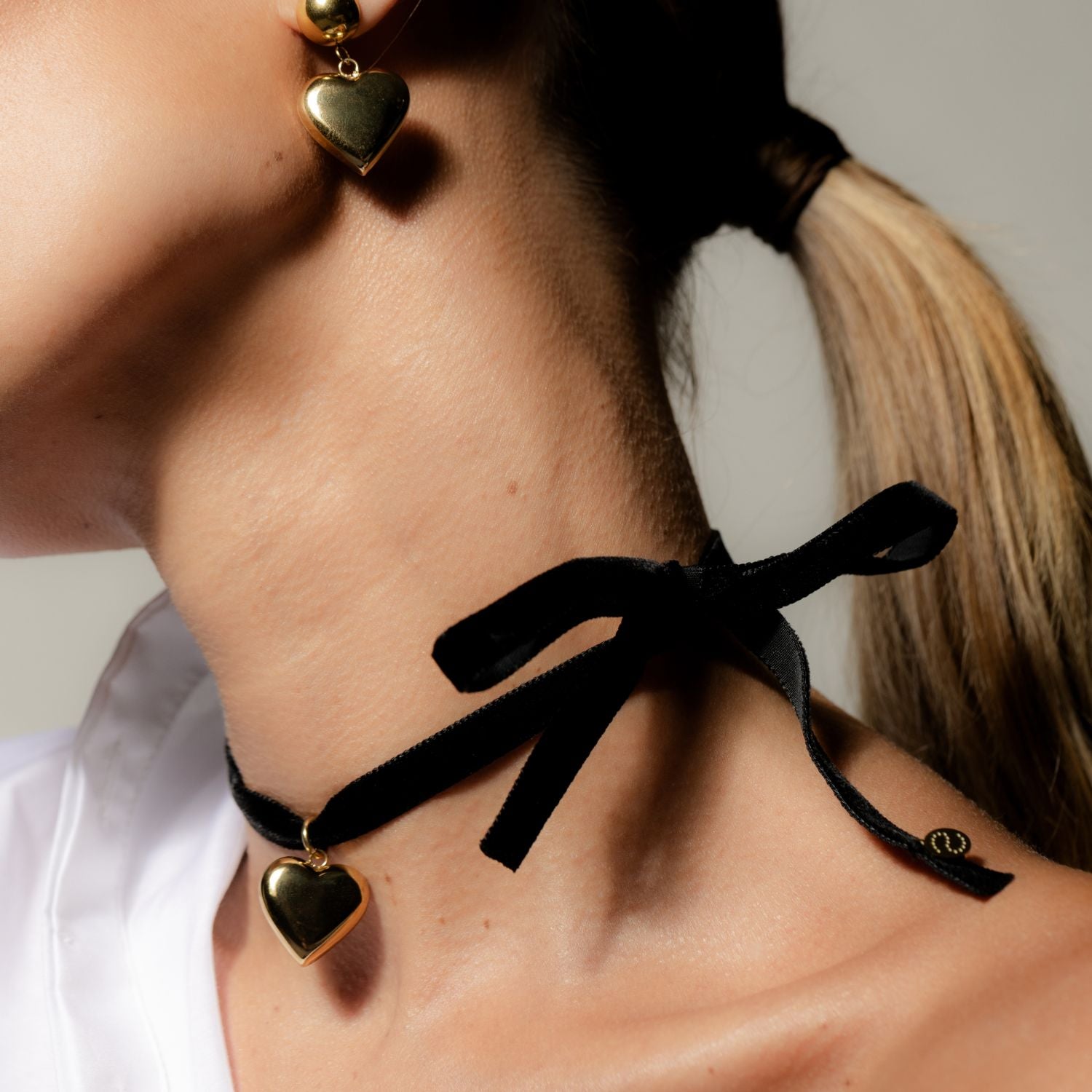 Silk & Steel cupid choker necklace in black velvet ribbon and puffed heart pendant in 14k gold-plated stainless steel.