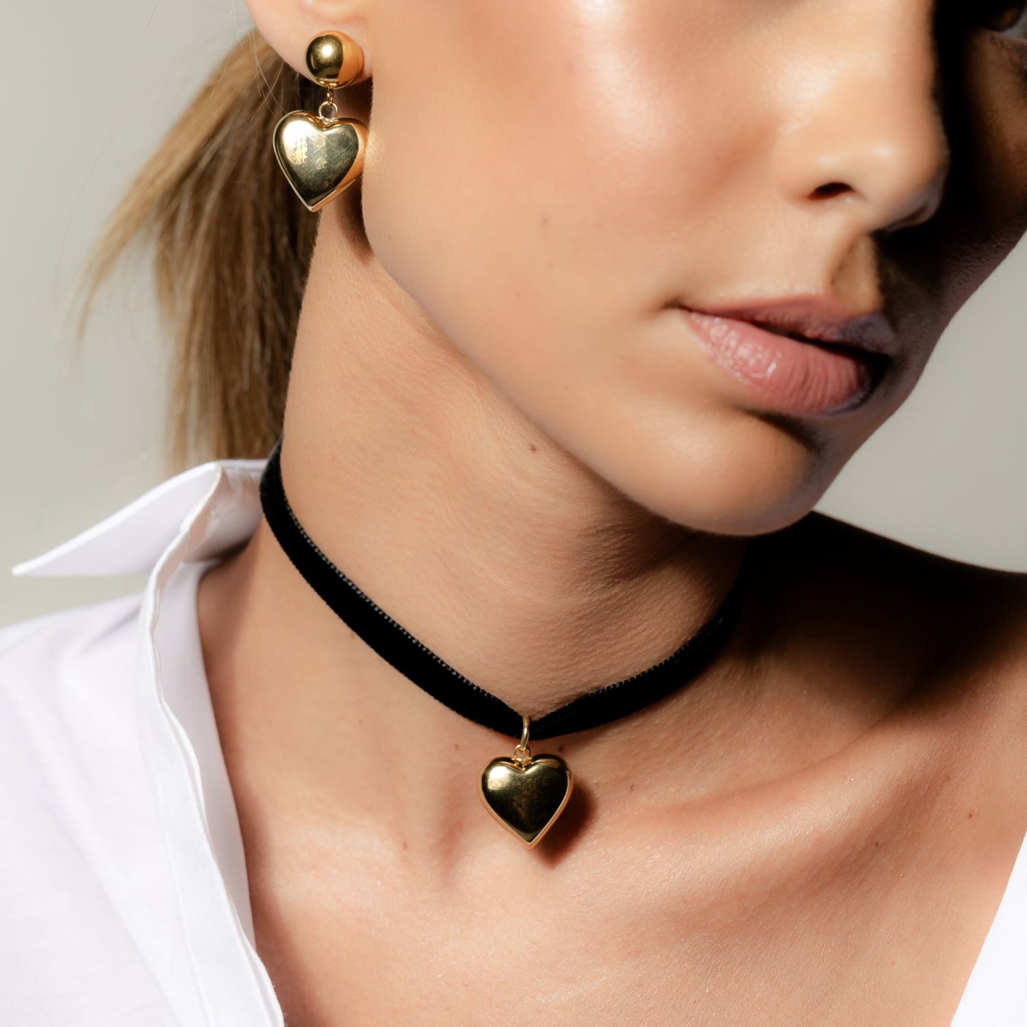 Silk & Steel cupid choker necklace in black velvet ribbon and puffed heart pendant in 14k gold-plated stainless steel.