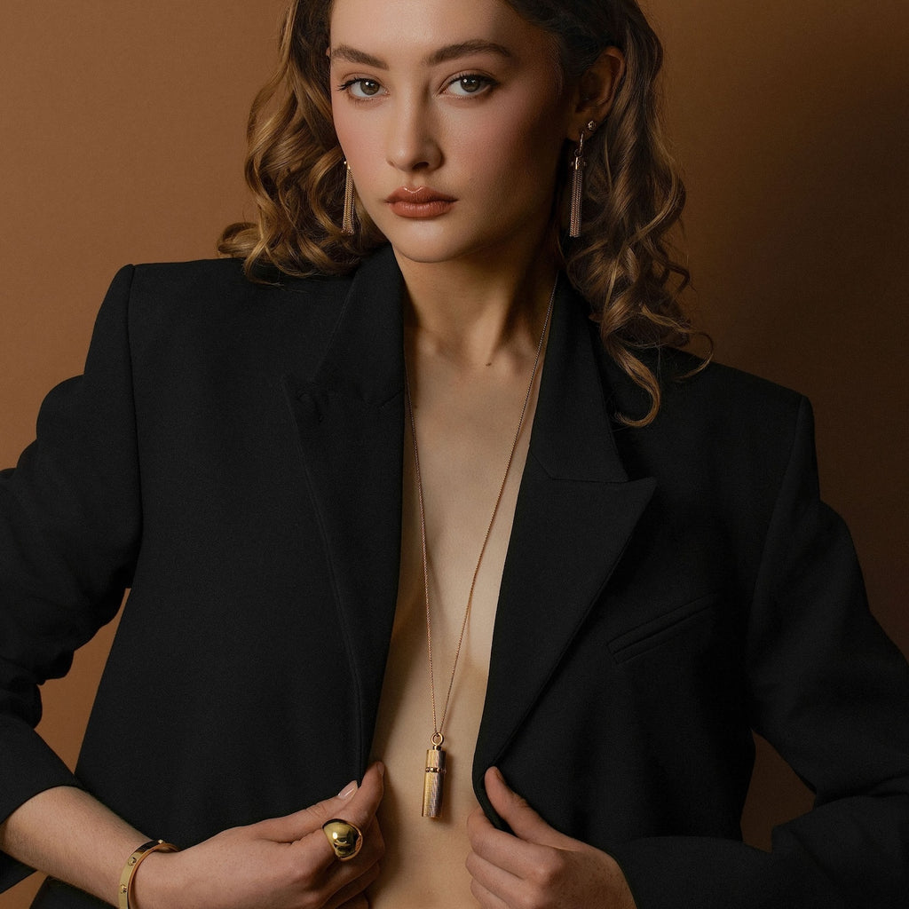 Model wears Silk & Steel statement Tassel Earrings and Odyssée Capsule Necklace in 14k gold-plated stainless steel.