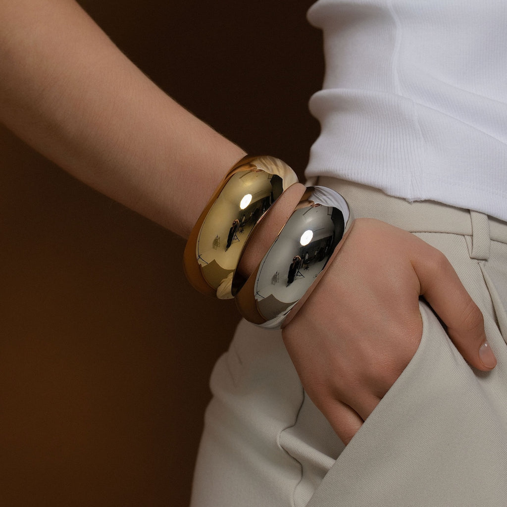 Silk & Steel two tone Globe Cuff stack in high-polished silver and gold-plated stainless steel.