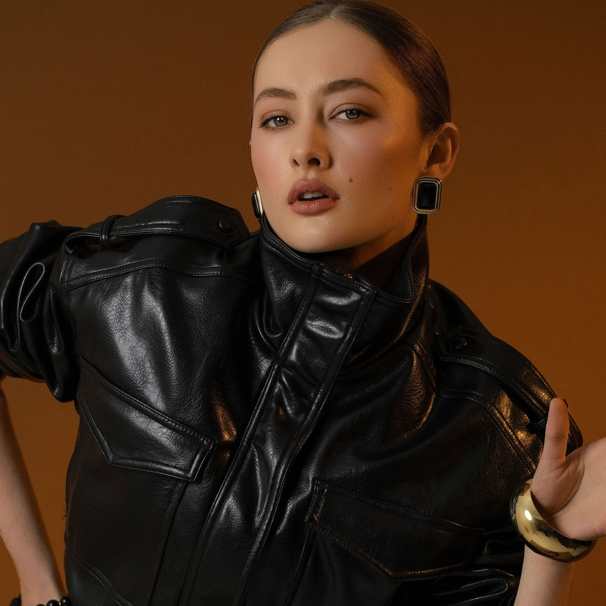 Model wears Silk & Steel statement Eclipse Earrings with black onyx in 14k gold-plated stainless steel.