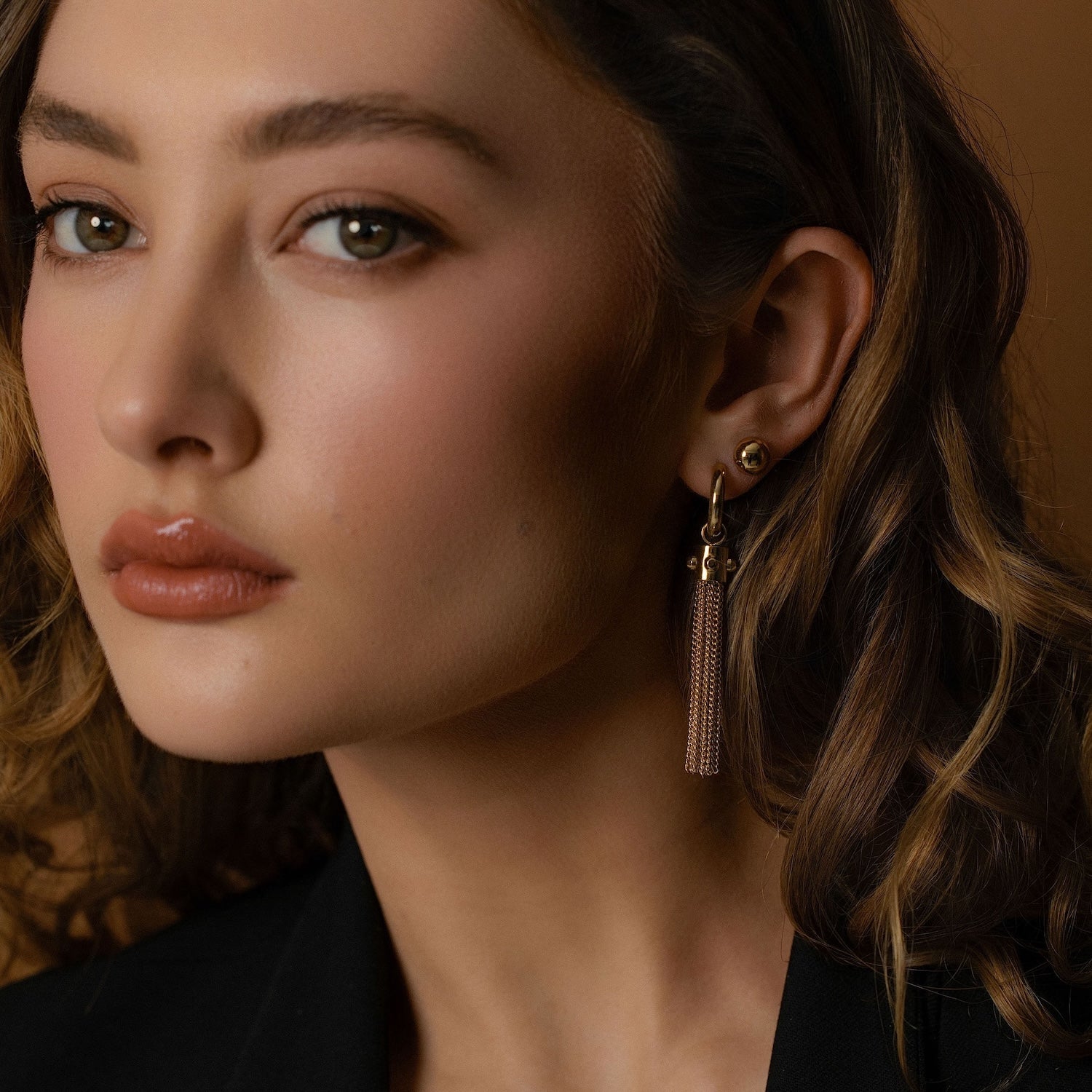 Model wears Silk & Steel Tassel Earrings and Dome Studs Lariat in 14k gold-plated stainless steel.