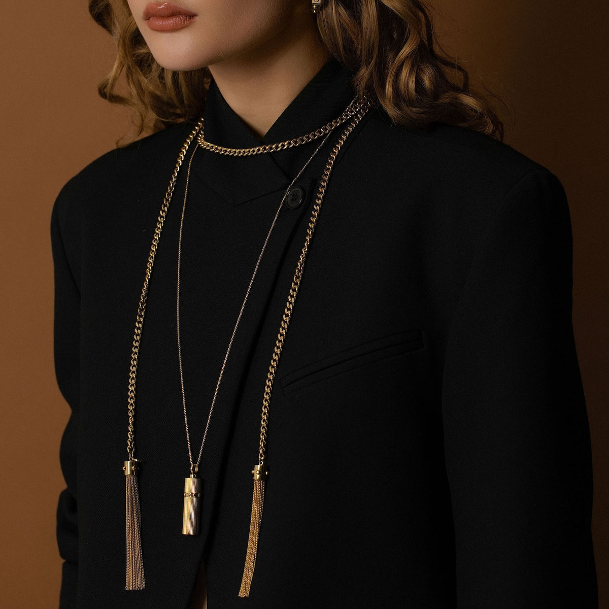 Model wearing Odyssée Lariat layered with Capsule Necklace in 14k gold-plated stainless steel.