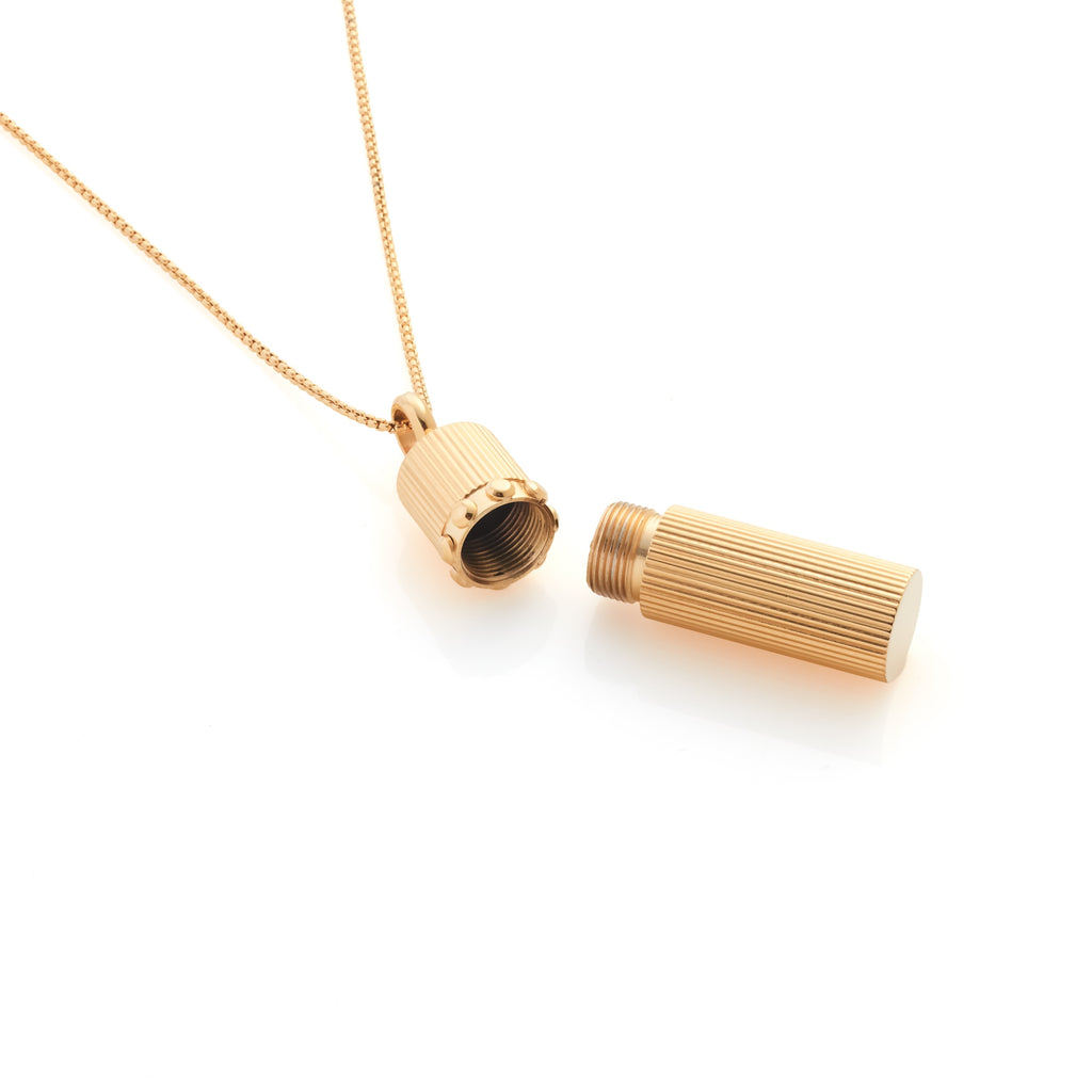 Silk & Steel Capsule Necklace featuring a 14k gold-plated stainless steel keepsake capsule pendant.